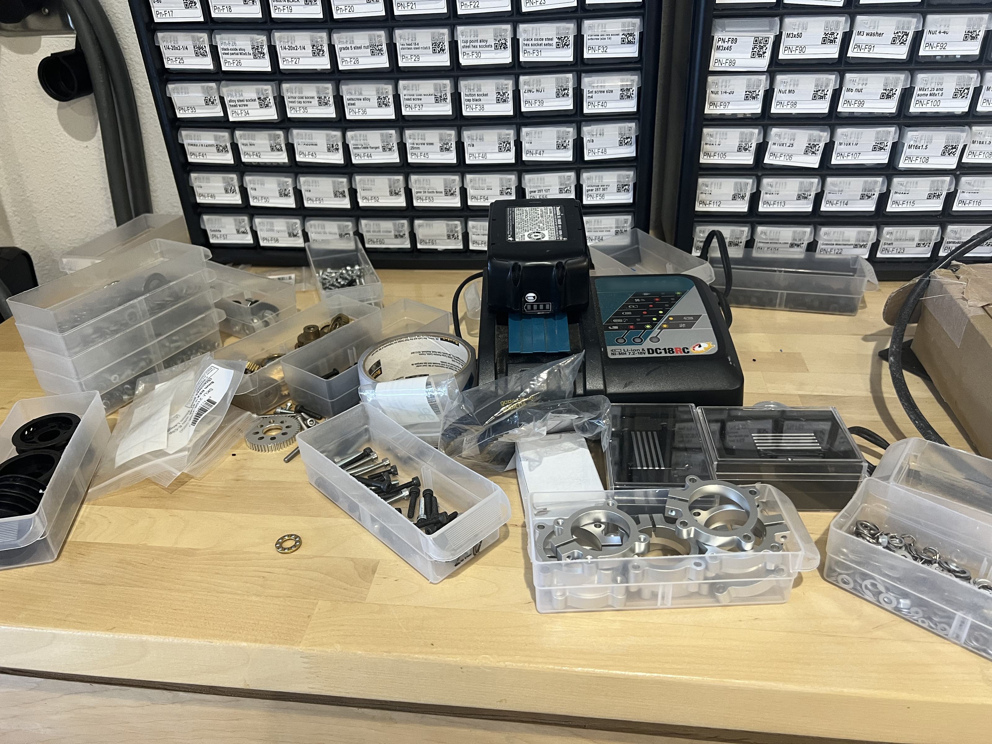 Zooming into the workshop photo: the workbench, the parts cabinet, row 5, and drawer PN-F40 labelled Set screw size m4